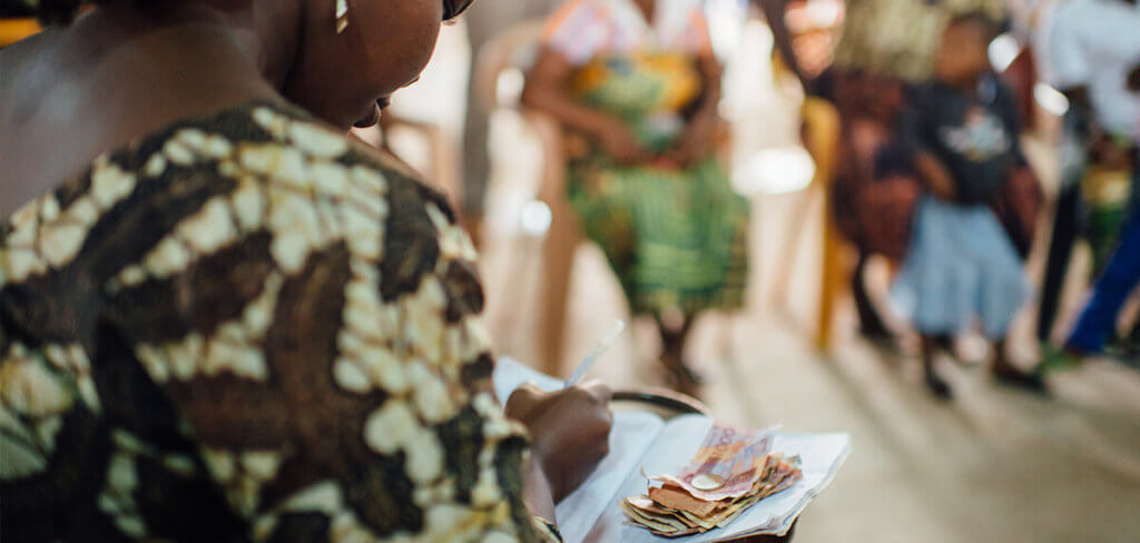 Woman in a savings group counting money