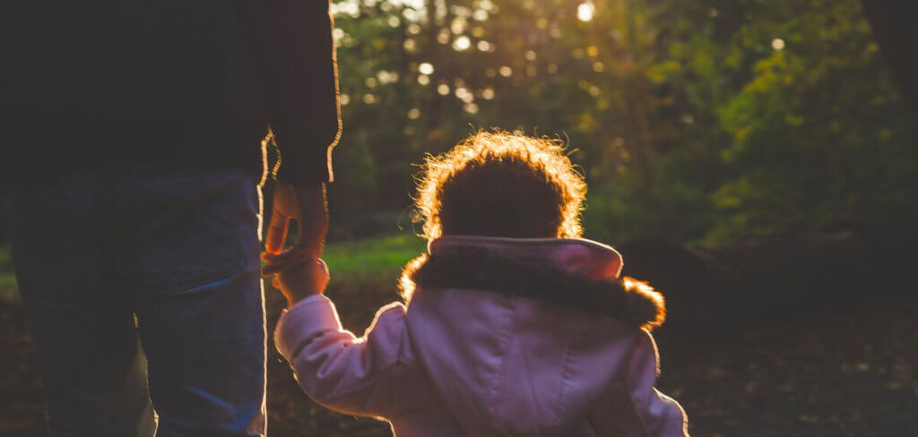 A child hold's an adult's hand