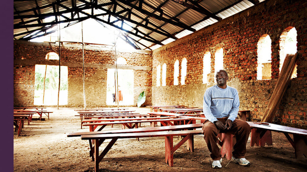 A man sitting on a bench in a church in West Africa