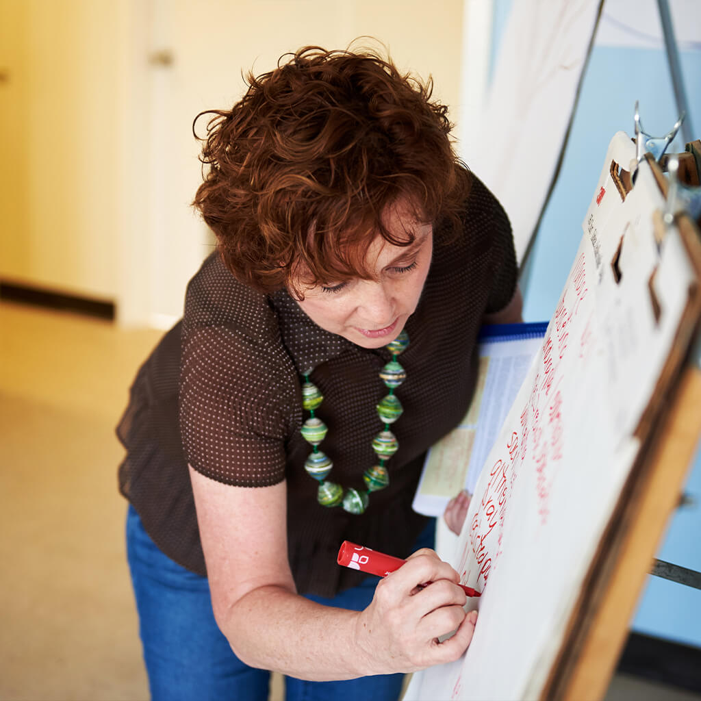 Woman writing on a flipchart