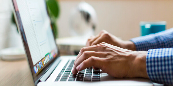 A person typing on a laptop