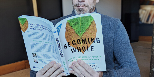 Man reading Becoming Whole book