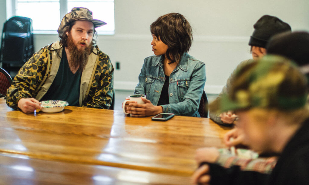 group of people talking around a table